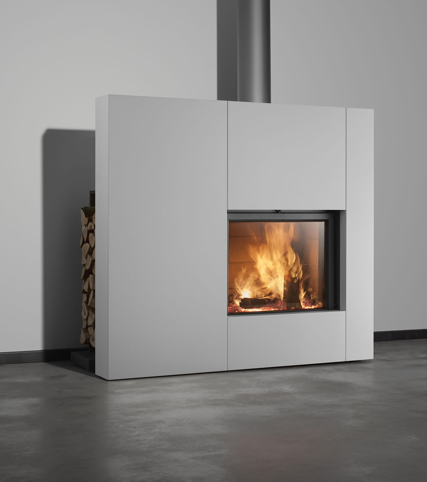 Stuv 21 single sided fireplace with white cladding and wood storage